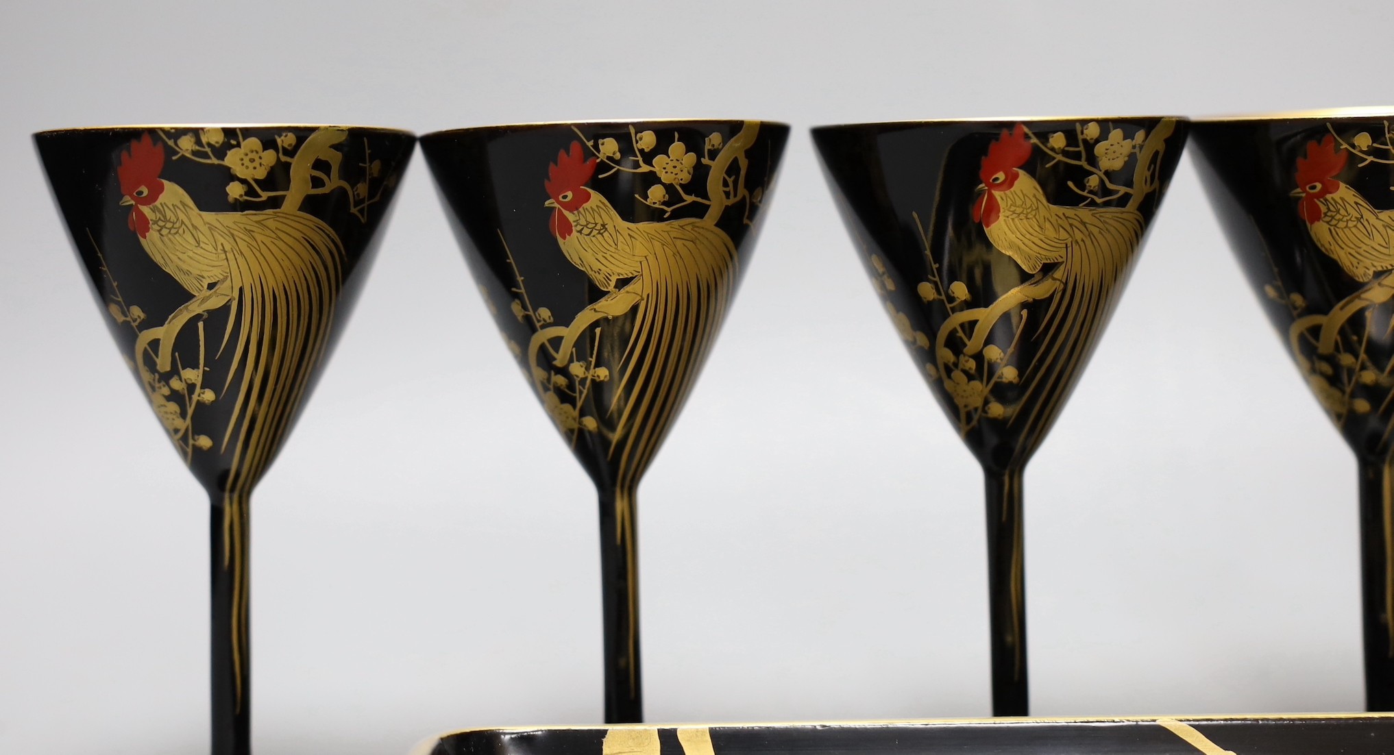 A set of six Japanese lacquer cocktail or liqueur cups and a similar tray